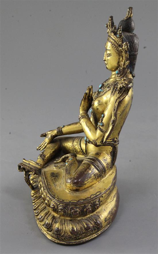 A Tibetan gilt copper alloy figure of Green Tara, 14th-15th century, height 21.3cm